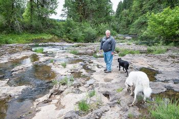 Marcus Larson/News-Register<br/>
David Young enjoys walking around Blackwell Park near Willamina with his two dogs, Merlin and Lily.