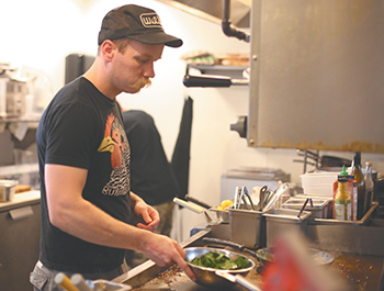 Rockne Roll/News-Register</br>Kyle Christensen is chef at The Diner.